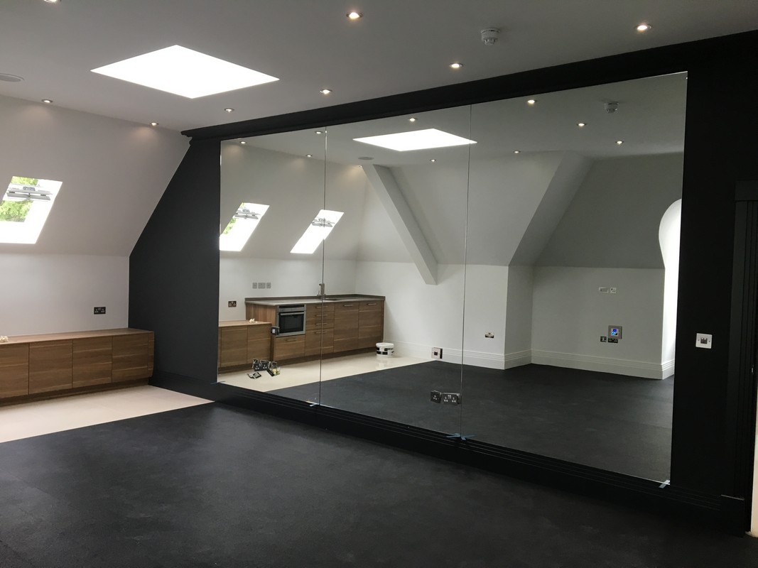 Frameless glass wall dividing loft conversion in Amersham